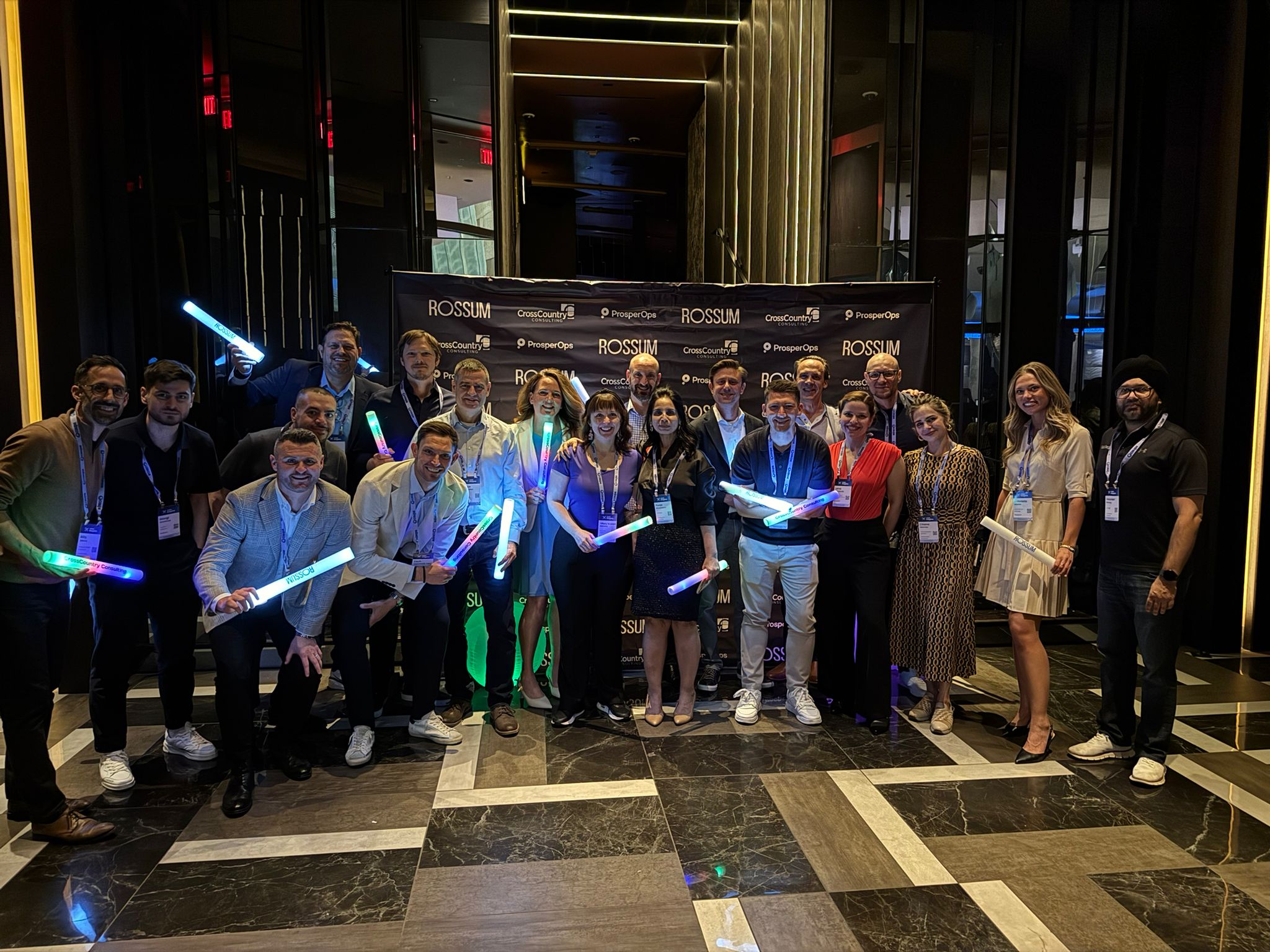 Group picture of the Rossum team alongside the team at CrossCountry Consulting in front of the nightclub.
