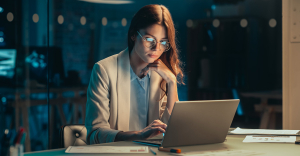 Best data extraction tools. Person sat working on a laptop.
