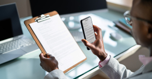 Person sat at desk using OCR technology to scan a document.