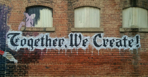 Grafitti that reads - Together, we create. In reference to AI human collaboration.