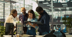 What is a shared service center - people standing around a computer in a large SSC.