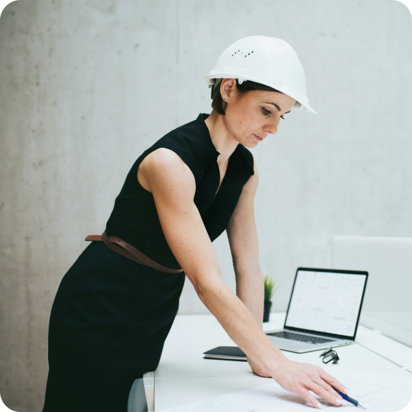 Construction document management software being used by a person wearing a hard hat.