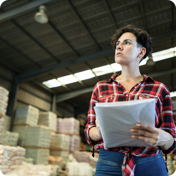 Transportation and logistics automation image of a person stock taking in a warehouse.